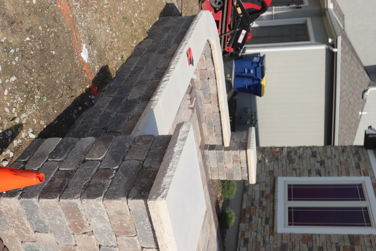 Seat wall with pillars and natural stone caps