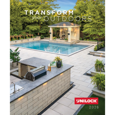 Unilock paver pool deck with a pavilion and an outdoor kitchen with a lit seat wall